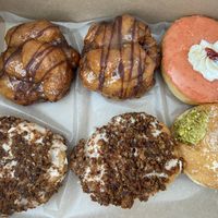 Banana chocolate chip fritters, strawberry donut, carrot cake donuts, pistachio cream donut   at bloomer's in Burlington