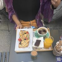 Brunch menu, smoked tofu toast, granola, coffee, orange juice and desert.   at Mala Leche in Malaga