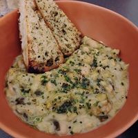 Creamy leek and butter bean casserole with homemade garlic bread  at Nooch Bar and Kitchen in Stirling