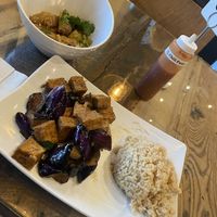 Szechuan dumplings, Eggplant & Tofu with brown rice  at Vegan District Asian Eatery in Loma Linda