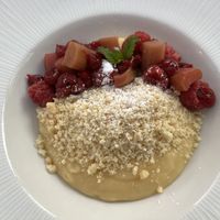 Fabulous custardy dessert with great fruit and crunch nut topping    at The Manor House Hotel in Moreton-in-marsh