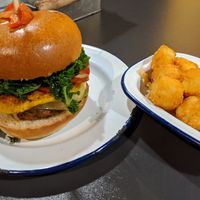 Breakfast burger and side of tater tots at V Rev Vegan Diner in Manchester