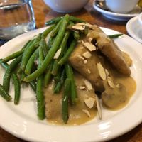 Tempeh with gravy, mashed red potatoes underneath and topped with green beans and almonds.  at Detroit Vegan Soul - East in Detroit