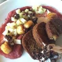 Gluten-free vegan banana french toast with rhubarb compote, fruit salad & coconut cream on the side.  at The Acorn in Vancouver