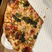 New York style pizza with red pepper, cherry pepper, serrano pepper, garlic spinach, garlic, herbs, and vegan cheese  at Smash Pizza in Bettendorf