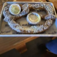 A very blurry picture of the giant everything pretzel with vegan cheese sauce  at Blue Point Brewpub in Patchogue