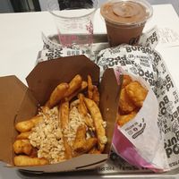 Vegan poutine, potato tots, two burgers and two drinks at Odd Burger in Calgary