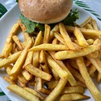 Tiki Vegan Burger (marinated tofu with lettuce, tomatoes, pickles, red onions, carrots, cabbage, sweet and sour mild spice red sauce) with French fries  at Tiki Ma'a in Moorea
