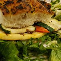 Grilled vegetable sandwich on foccacia bread with side salad. Needs a bit more flavor. at The Pizza Grille in Carlisle