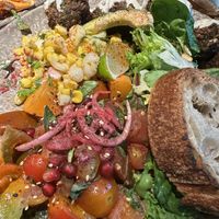 Falafel with street corn and tomatoes   at Honest Greens - Caleido in Madrid