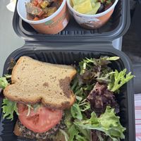 Black Bean & Quinoa Burger on a Gluten Free Bun with Green Salad. Sides of Roasted Veggies and Fruit. Did not disappoint. Excellent food    at Frothy Monkey in Birmingham