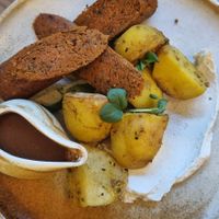 Roasted potatoes, gravy and chickpea sausages at Vita Rama in Sofia