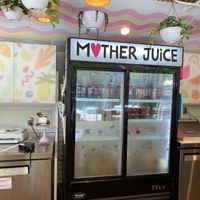 Counter and refrigerator with Mother Juice sign at Mother Juice in Cambridge