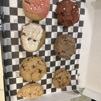 Left to right: strawberry, red velvet, cinnamon roll, cookies and cream, chocolate chip, oatmeal raisin, and birthday cake  at MidnighTreats in Arlington