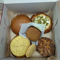 Inside the Mid-Autumn Festival box, scallion bun, koign amann, almond cookie, pineapple bun, mushroom BBQ bun, and double "yolk" moon cake! at Tai Zhan Bakery in Saratoga