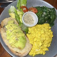 Vegan Scramble - scrambled tofu with spinach & mushrooms (no mushrooms available so we opted for avocado), grilled tomato and fresh salad  at Coffee & Thyme in 