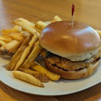 Pesto Chick'n Parm Sandwich with Golden Fries at Veggie Grill by Next Level in Portland