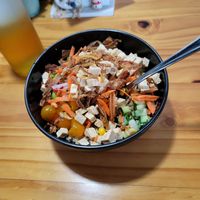 A vegan bowl with tofu, edamame, shredded carrots, crispy onions, cucumber, kale and quinoa  at Luna's Bowls in Liberia