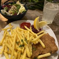 Schnitzel mit pommes & salat (€8.60) w/ sparkling lemon water 😋 at Cafe Erde in Graz
