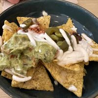 Nachos with cheese, peppers, guacamole… worth a try!   at La Oveja Negra in Madrid