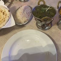 Left to right at the front of the photo - peshwari naan, coconut rice, sag aloo, Chana masala  at Sabor de la India in Tenerife