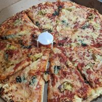 Basil and artichoke pizza with vegan cheese at Glass Nickel Pizza Co in Appleton