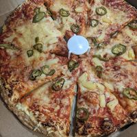 Pineapple and jalapeno pizza with vegan cheese at Glass Nickel Pizza Co in Appleton