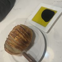 Fresh house made hot sourdough loaf. Soft in the middle and crispy crust. So good! Balance and olive oil to dip in   at Vechos Eatery & Taproom in Granite Bay