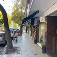 Street--notice "V" sign and outdoor seating at Craft Vegan Bakery Botánico in Buenos Aires