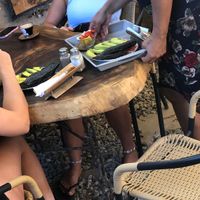 Black bread , avocado tomatoes and onions, bowl of fruits and coffee  at Café Taganga in Santa Marta