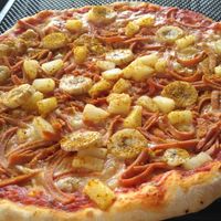 Vegan Pizza Tropicana with veg ham, cheese, banana, curry powder, pineapple. It tasted OK. The dough was quite good - thin and crispy. I personally disliked the combination of banana and curry. at O'Mamma Mia in Stockholm