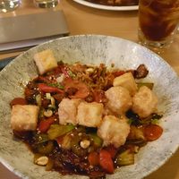 Hunan Kung Pao and pizza in the background at Earls Kitchen + Bar - Test Kitchen in Vancouver
