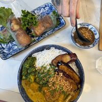 Curry vermicelli bowl with tofu salad rolls  at Ôngbà Vietnamese Eatery in Vancouver