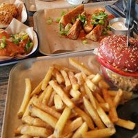 Beyond Meat burger with fries, seitan and cauliflower wings all vegan. Top left are mac and cheese balls which are vegetarian (not mine) at BrewDog in Hull