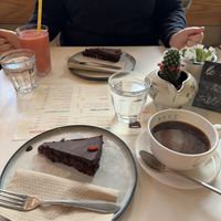 Large Americano and Raspberry cake. Complementary water   at Coffee Room in Amsterdam