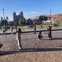 You can look out onto the main Plaza from the restaurant, where students practice dancing in the morning. at El Jardin Healthy Food And Coffee in Cusco