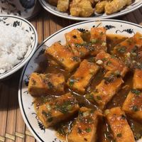 Tofu in tomato sauce and sweet potatoes fried with sesame.  at Tam Coc Ngo Dong Homestay and Vegan Restaurant in Ninh Binh