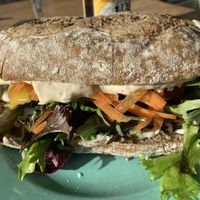 Sandwich with grilled eggplant, mustard dressing and greens  at The Break Cafe in Thisted