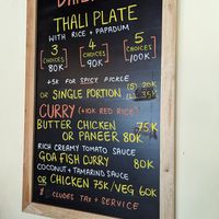 Thali plate with menu that changes daily as well as permanent curry options. at Krishna's Kitchen in Pecatu