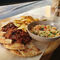 Platter with Beyond Burger, Chips, mushroom Gyros and salad at Veganato in Crete