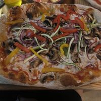 Huge pizza with peppers, onions, mushrooms and vegan cheese which asked them not to cut ( cross contamination)  at Pizzeria La Pinsa in Holbox