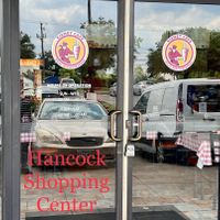 Kismet Cafe door with hours as of June 2023 at Kismet Cafe in Austin