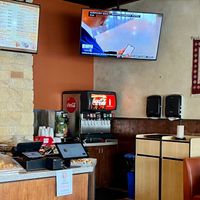 Supplies area & TV in every corner at Kismet Cafe in Austin