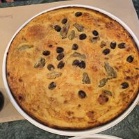Farinata with olives and artichokes at Pizzeria Grains in Cagliari
