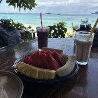 Large fruit plate, smoothies and the beach in the background   at Paradise Pearl in Koh Phi Phi