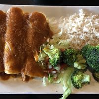 Guacamole Enchiladas with a red sauce and coconut rice.  at Botanas Restaurant and Bar in Branson