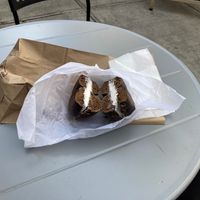 Pumpernickel bagel, vegan shmear, on an outdoor table  at Grabstein's Bagels in New York City