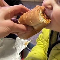 My toddler Enjoying chilli dog   at Disneyland - Casey's Corner in Chessy