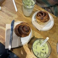 iced vanilla matcha latte with oat milk & cinnamon bun  at Doppio Coffee Warehouse Kentish Town in North West London