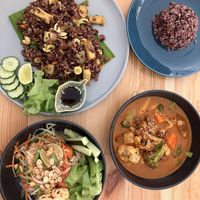 From top left to bottom right: Pineapple fried rice, serving of rice, papaya salad, massaman curry  at Penne in Koh Samui